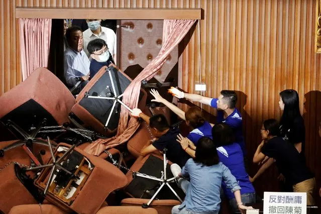 Lawmakers from Taiwan's ruling Democratic Progressive Party (DPP) scuffle with lawmakers from the main opposition Kuomintang (KMT) party, who have been occupying the Legislature Yuan, in Taipei, Taiwan, June 29, 2020. (Photo by Ann Wang/Reuters)