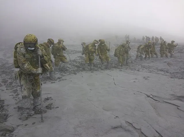 Japan Self-Defense Force (JSDF) soldiers conduct rescue operations on Mount Ontake, which erupted September 27, 2014 and straddles Nagano and Gifu prefectures in central Japan, in this October 7, 2014 handout photograph released by the Joint Staff of the Defence Ministry of Japan. Two more bodies were found on Mount Ontake on Tuesday, nearly a week and a half after the eruption that killed at least 51 people, Japanese media reported. (Photo by Reuters/Joint Staff of the Defence Ministry of Japan)