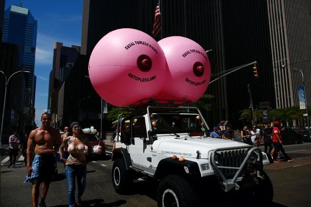 People take part in the GoTopless Pride Parade on August 28, 2016 in New York. Women around the US are going topless in celebration of GoTopless Day, focused on promoting gender equality and women's rights to bare their breasts in public. (Photo by Kena Betancur/AFP Photo)