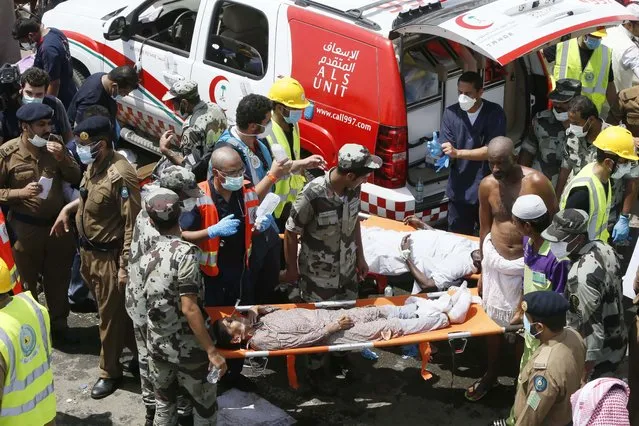 Emergency services attend to victims crushed in a crowd in Mina, Saudi Arabia during the annual hajj pilgrimage on Thursday, September 24, 2015. (Photo by AP Photo)