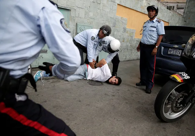 A protester (C) is detained during a rally to demand for a referendum to remove Venezuela's President Nicolas Maduro in Caracas, Venezuela, September 1, 2016. (Photo by Marco Bello/Reuters)
