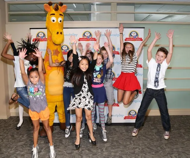 Toys "R" Us mascott Geoffrey (C) poses for a picture with President of Play contestants during the Top 10 President of Play semifinalists visit Toys "R" Us Global Resource Center on September 1, 2016 in Wayne, New Jersey. (Photo by Bennett Raglin/Getty Images for Toys "R" Us)