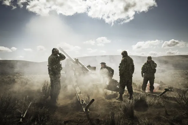 “Last round out”. After more than twenty years of service in the Canadian Armed Forces, Sergeant AG fires his traditional last round in the field before retirement. Photo location: Yakima, WA. (Photo and caption by Albert Law/National Geographic Photo Contest)