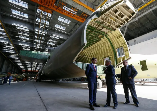 Officials stand near an airframe for the second Antonov-225 Mriya plane at Antonov aircraft plant in Kiev, Ukraine, September 7, 2016. (Photo by Valentyn Ogirenko/Reuters)