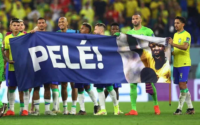 Players of Brazil hold a banner showing support for former Brazil player Pele at the end of the FIFA World Cup Qatar 2022 Round of 16 match between Brazil and South Korea at Stadium 974 on December 05, 2022 in Doha, Qatar. (Photo by Carl Recine/Reuters)