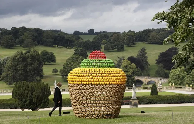A visitor walks past a piece entitled “Fruitcake” by Joana Vasconcelo, during the Beyond Limits selling exhibition at Chatsworth House near Bakewell in Britain, September 9, 2016. (Photo by Darren Staples/Reuters)