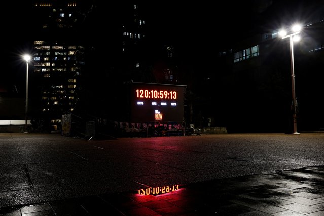 A Tel Aviv plaza has been renamed “Hostages Square” and hosts regular demonstrations and other solidarity events. One winter night, on February 4, 2024 it was abandoned save for a large screen, ringed by small blue-and-while Israeli flags, which counted, to the second, the duration of the Gaza captivity. The digits were reflected in puddles between the uneven pavings. (Photo by Susana Vera/Reuters)