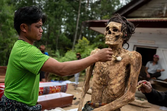 Family members clean the preserved body of their relative during a traditional ritual called “Manene” in Panggala, Nort Toraja, South Sulawesi, Indonesia, Tuesday, August 25th 2020. (Photo by Hariandi Hafid/ZUMA Wire/Rex Features/Shutterstock)
