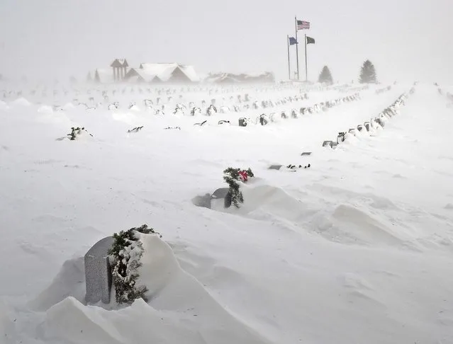 Rows of headstones at the North Dakota Veterans Cemetery are blanketed by drifting snow Thursday, December 22, 2022, in Mandan, N.D. (Photo by Tom Stromme/The Bismarck Tribune via AP Photo)