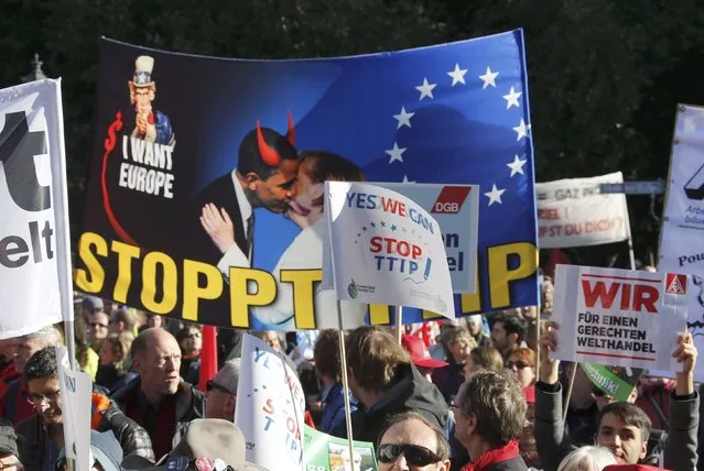 Consumer rights activists take part in a march to protest against the Transatlantic Trade and Investment Partnership (TTIP), mass husbandry and genetic engineering, in Berlin, Germany, October 10, 2015. The European Union is pursuing a trade accord with the United States, called the Transatlantic Trade and Investment Partnership (TTIP), that would encompass a third of world trade and nearly half of global GDP. (Photo by Fabrizio Bensch/Reuters)