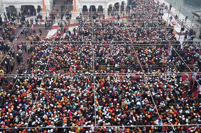 Devotees crowd to visit the Golden Temple on the occasion of New Year's Day in Amritsar on January 1, 2023. (Photo by Narinder Nanu/AFP Photo)