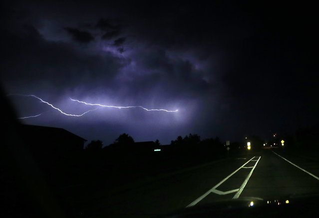 Lightning strikes cloud-to-cloud along a county road near Lawrence, Kan., Thursday, May 26, 2016. Severe storms that produced at least one tornado moved through the area overnight. (Photo by Orlin Wagner/AP Photo)