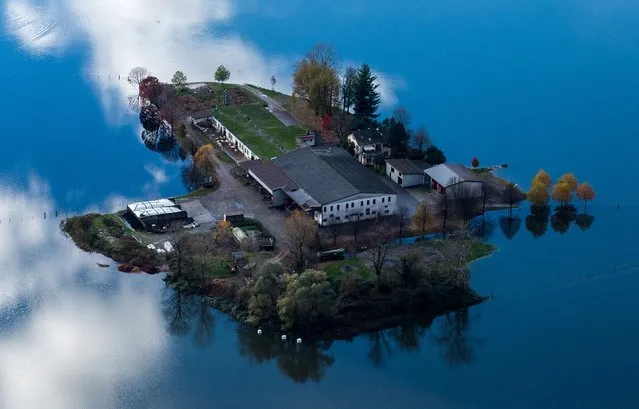 An aerial view of a flooded area near Lake Maggiore shows a farm surrounded by water near the village of Magadino in Ticino, Switzerland, 16 November 2014. Heavy rain has caused flooding in the region. (Photo by Gabriele Putzu/EPA)