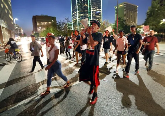 Protesters cross Commerce Street during the Next Generation Action Network protest in downtown Dallas, Thursday, September 22, 2016. Dominique Alexander the leader of the Dallas group behind a July march at which five police officers were killed by a sniper has led a downtown Dallas protest rally the day he left prison. He led a rally Thursday night to protest the fatal police shooting of black men in Tulsa, Okla., and Charlotte, N.C. (Photo by Tom Fox/The Dallas Morning News via AP Photo)