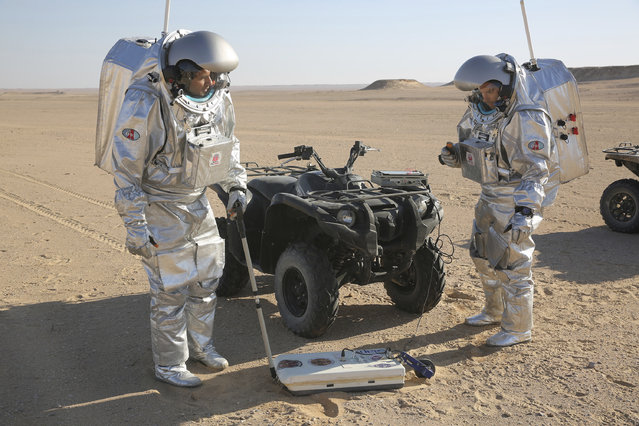 In this February 7, 2018, photo, two scientists test space suits and a geo-radar for use in a future Mars mission in the Dhofar desert of southern Oman. The desolate desert in southern Oman resembles Mars so much that more than 200 scientists from 25 nations organized by the Austrian Space Forum are using it for the next four weeks to field-test technology for a manned mission to Mars. (Photo by Sam McNeil/AP Photo)