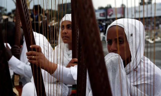 A church choir members play on harps during the Meskel Festival to commemorate the discovery of the true cross on which Jesus Christ was crucified on at the Meskel Square in Ethiopia's capital Addis Ababa, September 26, 2016. (Photo by Tiksa Negeri/Reuters)