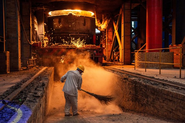 A worker brooms the floor at a steel factory in Huai'an, in China's eastern Jiangsu province on July 22, 2025. (Photo by AFP Photo/China Stringer Network)