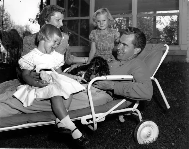 Sen. Richard Nixon, Republican Vice Presidential Candidate, relaxes with his family on the lawn of their Washington D.C. home on September 28, 1952. With the Senator is his wife, Pat, their children Julie and Patricia, and their cocker-spaniel, Checkers. (Photo by AP Photo)