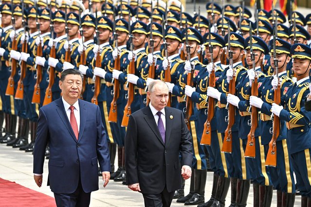Russian President Vladimir Putin (R) is greeted by a ceremonial guard and received a red-carpet welcome in Beijing, China on May 16, 2024. Putin will pay a two-day official visit at the invitation of his Chinese counterpart Xi Jinping (L). (Photo by Kremlin Press Office/Handout/Anadolu via Getty Images)
