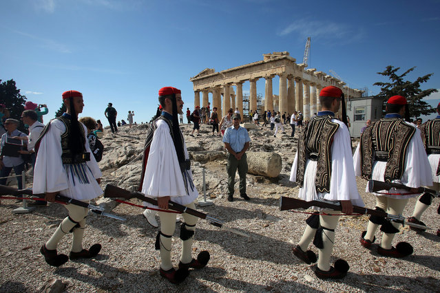 Greek Presidential Guards are seen in front of the Parthenon temple at the Acropolis hill during a ceremony marking the 72nd anniversary of the liberation of Athens from the Nazi occupation from 1941 to 1944 in Athens, Greece, 12 October 2016. (Photo by Alexandros Vlachos/EPA)