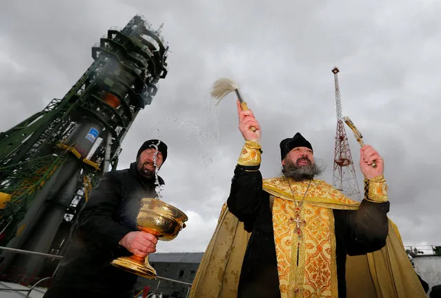 An Orthodox priest conducts a blessing in front of the Soyuz MS-02 spacecraft set on the launch pad at the Baikonur cosmodrome, Kazakhstan October 18, 2016. (Photo by Shamil Zhumatov/Reuters)