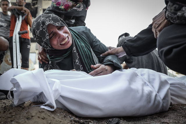 Mother Nesrin Mehre, mourns near the body of Muhammad Mehre was killed in an Israeli attack on al-Nasr neighborhood in northwestern Gaza, on September 23, 2025. His body was taken from al-Shifa Hospital for burial. (Photo by Khames Alrefi/Anadolu via Getty Images)