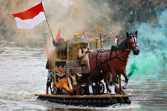 People ride on a boat shaped like a horse-drawn carriage and made from recycled materials, mostly plastic bottles, during Festival Cilung or “Love the Environment” Festival, held on the Ciliwung River, one of the most polluted rivers in the world, to raise public awareness about river pollution in Jakarta, Indonesia, on September 28, 2025. (Photo by Willy Kurniawan/Reuters)