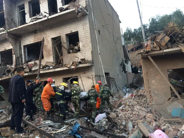 Rescue workers search at site after an explosion hit a town in Fugu county, Shaanxi province, China, October 24, 2016. (Photo by Reuters/China Daily)
