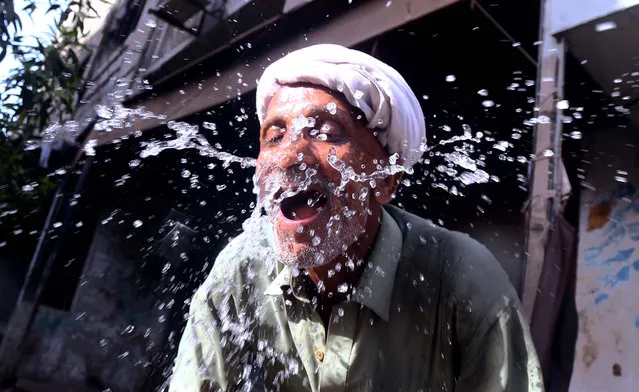 A Pakistani man splashes water on his face on the eve of World Water Day, in Karachi, Pakistan, 21 March 2018. International World Water Day is held annually on 22 March as a mean of highlighting the importance of freshwater and its management. (Photo by Rehan Khan/EPA/EFE)
