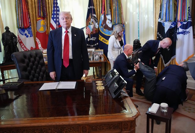 U.S. President Donald Trump stands by as attendees help Novo Nordisk executive Gordon Findlay after he collapsed during during an event on lowering drug prices in the Oval Office at the White House on November 06, 2025 in Washington, DC. Trump announced that his administration has reached agreements with drugmakers Eli Lilly and Novo Nordisk that would lower the price of some GLP-1 weight loss medications. (Photo by Andrew Harnik/Getty Images)