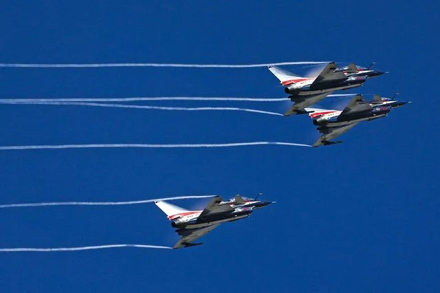 China's J-10 fighter jets from the People's Liberation Army Air Force August 1st Aerobatics Team perform during a media demonstration at the Korat Royal Thai Air Force Base, Nakhon Ratchasima province, Thailand, November 24, 2015. (Photo by Athit Perawongmetha/Reuters)