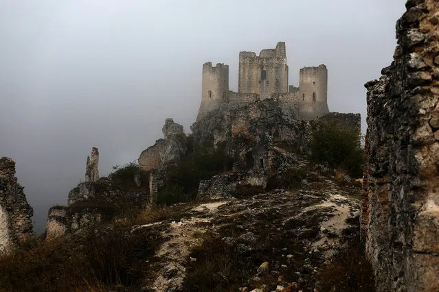 The ruins of a castle stand above the town of Rocca Calascio, close to Santo Stefano di Sessanio in the province of L'Aquila in Abruzzo, inside the national park of the Gran Sasso e Monti della Laga, Italy, September 7, 2016. (Photo by Siegfried Modola/Reuters)