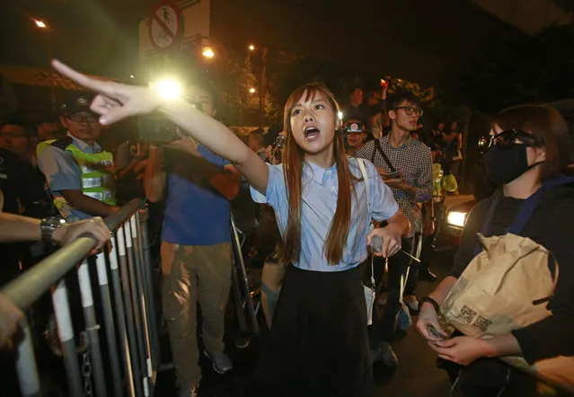 Newly elected Hong Kong lawmaker Yau Wai-ching, shouts at police officers after clashing as thousands of people march in a Hong Kong street, Sunday, November 6, 2016. Thousands of protesters marched in Hong Kong on Sunday, demanding that China's central government stay out of a political dispute in the southern Chinese city after Beijing indicated that it would intervene to deter pro-independence advocates. (Photo by Kin Cheung/AP Photo)