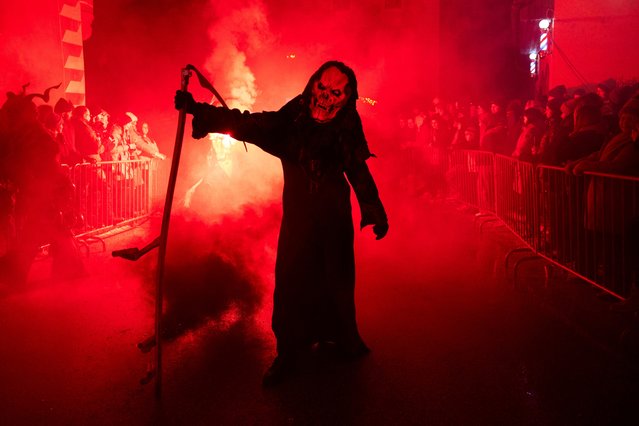A person wearing a costume and a mask participates in the traditional Perchten parade in Windischgarsten, Austria, on January 5, 2025. (Photo by Lisa Leutner/Reuters)