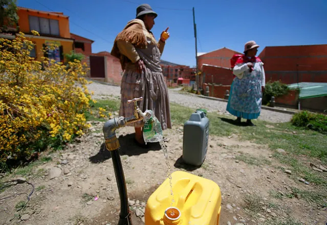 Women stand next to an emergency water point, as drought affects La Paz, Bolivia, November 14, 2016. (Photo by David Mercado/Reuters)