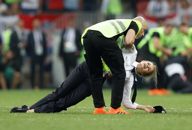 Stewards remove pitch invaders, p*ssy Riot members during the 2018 FIFA World Cup Final between France and Croatia at Luzhniki Stadium on July 15, 2018 in Moscow, Russia. The pitch invasion sparked a furious debate online with many tweeting support for the group, while others claimed they had spoiled a key moment for Croatia. (Photo by Darren Staples/Reuters)