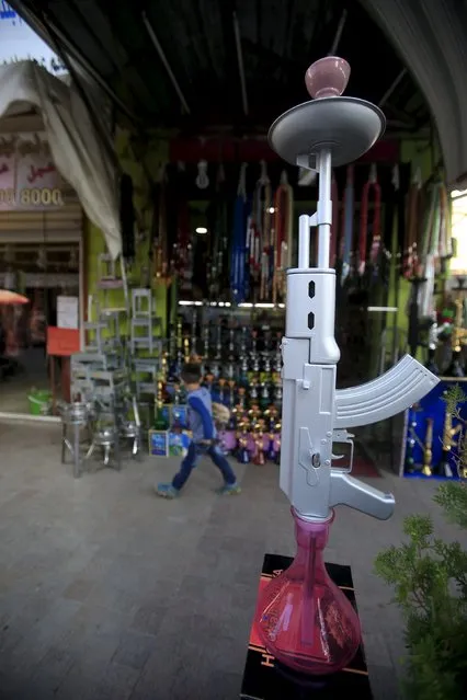 A hookah shaped like a rifle is displayed for sale in a souk at the port city of Sidon, southern Lebanon, December 23, 2015. (Photo by Ali Hashisho/Reuters)