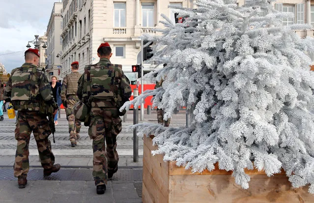French soldiers patrol past a Christmas market in Marseille, France, November 23, 2016. (Photo by Jean-Paul Pelissier/Reuters)