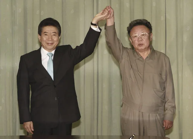 In this October 4, 2007 file photo, South Korean President Roh Moo-hyun, left, holds hands with North Korean leader Kim Jong Il after exchanging a joint declaration documents in Pyongyang, North Korea. The first inter-Korean summit in more than a decade follows meetings between Kim Jong Un’s father, Kim Jong Il, with South Korean presidents in 2007 and 2000. Each produced similar sounding vows to reduce tensions, replace the current armistice that ended the fighting in the 1950-53 Korean War and expand cross-border engagement. (Photo by Yonhap Pool Photo via AP Photo)