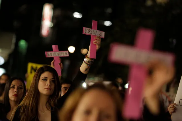 Women hold up pink crosses bearing the names of female victims during a rally against gender violence on the International Day for the Elimination of Violence Against Women, in Monterrey, Mexico November 25, 2016. (Photo by Daniel Becerril/Reuters)
