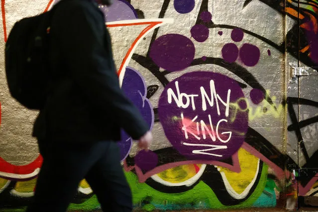 A person walks past graffiti that reads “Not My King” in London, Britain on May 9, 2023. (Photo by Henry Nicholls/Reuters)