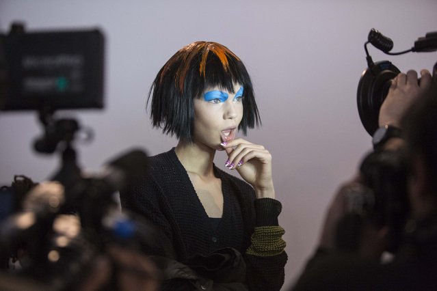 A model is filmed backstage before the Jeremy Scott Fall/Winter 2015 collection presentation at New York Fashion Week February 18, 2015. (Photo by Andrew Kelly/Reuters)