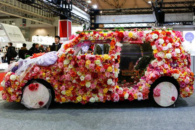 A custom car heavily decorated in flowers is shown on display at the 2016 Tokyo Auto Salon car show on January 15, 2016 in Chiba, Japan. TOKYO AUTO SALON 2016 is held from January 15 to 17, 2016. (Photo by Christopher Jue/Getty Images)