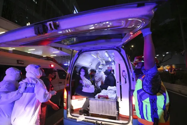 Rescue personnel help injured passengers at KLCC station after two light rail trains collided in a tunnel, injuring more than 200 people in Kuala Lumpur, Malaysia, Monday, May 24, 2021. (Photo by AP Photo/Stringer)