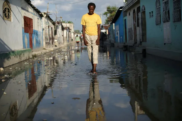 A man walks along a flooded street in Cite Soleil, Port-au-Prince, Haiti, April 26, 2018. (Photo by Andres Martinez Casares/Reuters)