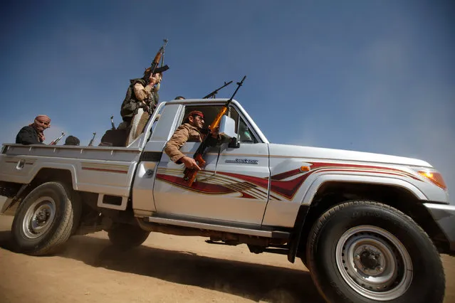 Tribesmen ride in a pick-up during a tribal gathering held to show support to the new government formed by Yemen's armed Houthi movement and its political allies, in Sanaa, Yemen December 6, 2016. (Photo by Khaled Abdullah/Reuters)