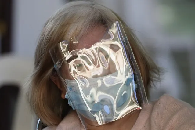 An elderly woman wearing a face shield waits after being inoculated with China's Sinovac COVID-19 vaccine in Quezon city, Philippines, Friday, May 14, 2021. The Philippine president has eased a coronavirus lockdown in the bustling capital and adjacent provinces to fight economic recession and hunger but still barred public gatherings this month, when many Roman Catholic summer religious festivals are held. (Photo by Aaron Favila/AP Photo)