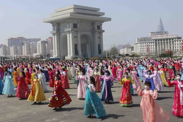 Women dance near the Arch of Triumph on the Day of the Sun, the birth anniversary of late leader Kim Il Sung, in Pyongyang, North Korea Thursday, April 15, 2021. (Photo by Cha Song Ho/AP Photo)