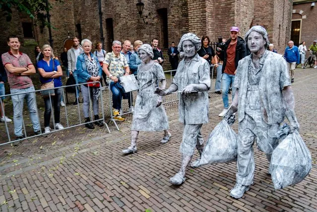Living statues take part in a demonstration by the CNV trade union, demanding better pay and appreciation for public sector workers in the Hague, the Netherlands on June 29, 2021. (Photo by Hollandse Hoogte/Rex Features/Shutterstock)