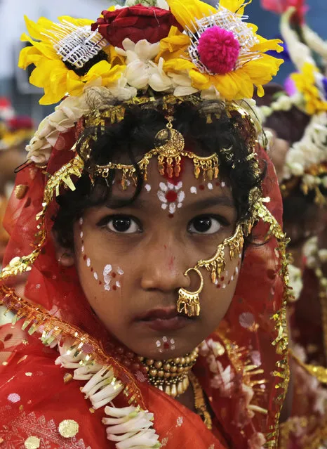 A young Hindu girl sits for a ceremony where she and other girls are worshipped as “Kumari”, or living goddess, during Ram Navami festival, at a temple in Kolkata, India, Saturday, March 28, 2015. (Photo by Bikas Das/AP Photo)